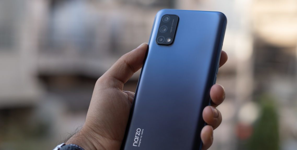 Realme-Narzo-30-Pro-review-in-hand-with-camera-and-logo-1200x675